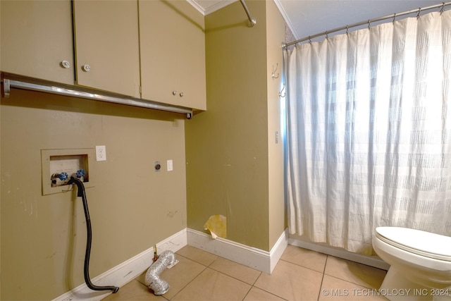 clothes washing area with electric dryer hookup, light tile patterned floors, and washer hookup