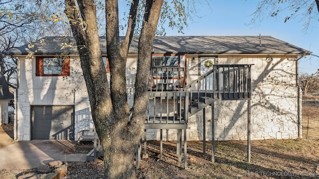 back of property featuring a garage