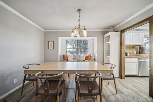 dining space featuring a chandelier, light wood-type flooring, a wealth of natural light, and crown molding