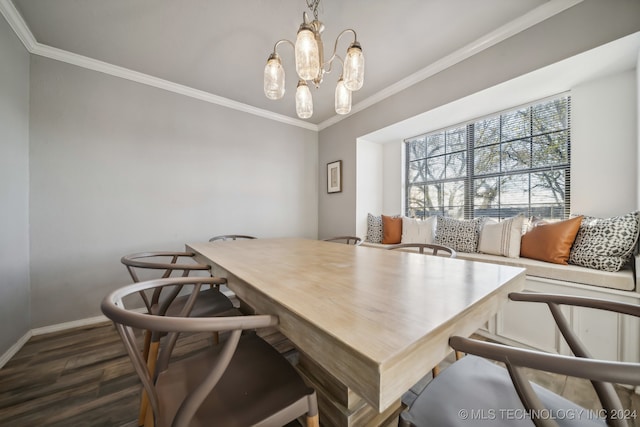 dining space with a notable chandelier, ornamental molding, and dark wood-type flooring