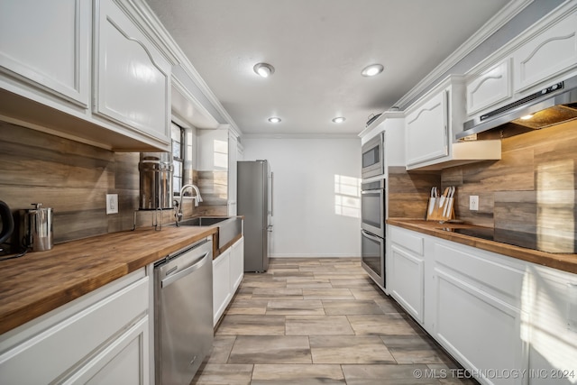 kitchen featuring white cabinets, sink, appliances with stainless steel finishes, and wooden counters