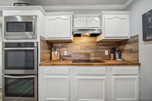 kitchen with white cabinets, crown molding, appliances with stainless steel finishes, and ventilation hood