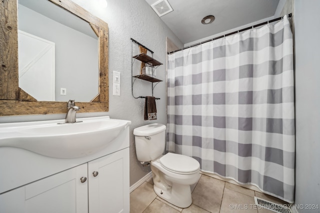 bathroom with tile patterned floors, vanity, and toilet