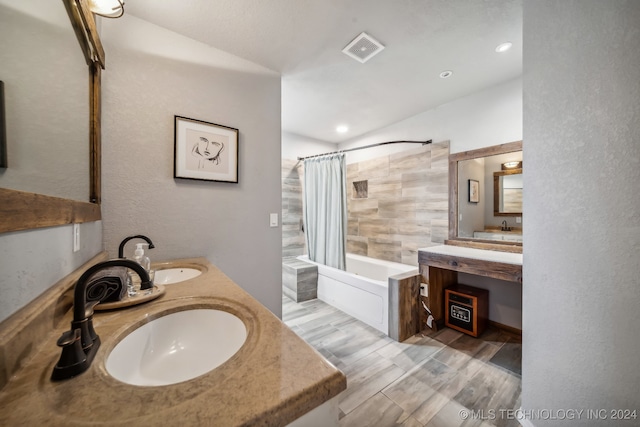 bathroom featuring wood-type flooring, vanity, and shower / bathtub combination with curtain