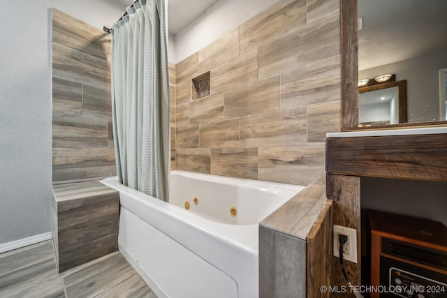 bathroom with hardwood / wood-style floors and shower / bath combo with shower curtain