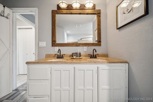 bathroom featuring hardwood / wood-style flooring and vanity