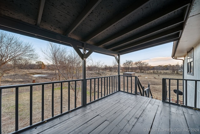 wooden terrace featuring a rural view