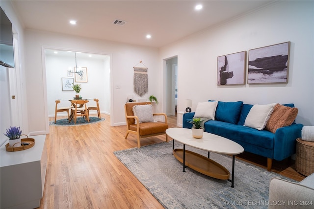 living room featuring a notable chandelier and wood-type flooring