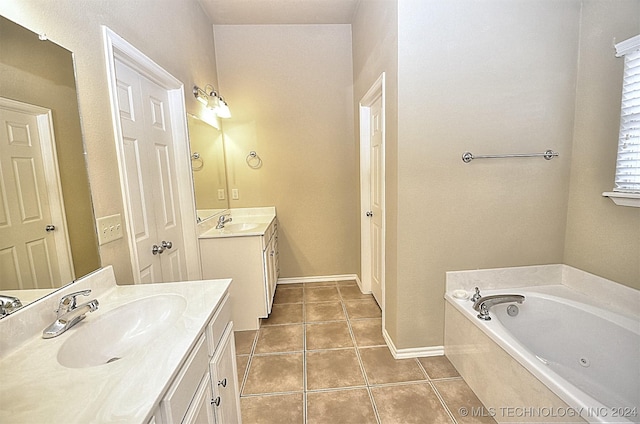 bathroom featuring tile patterned flooring, a bathtub, and vanity