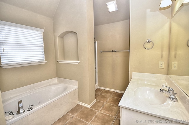 bathroom featuring tile patterned floors, vanity, lofted ceiling, and shower with separate bathtub