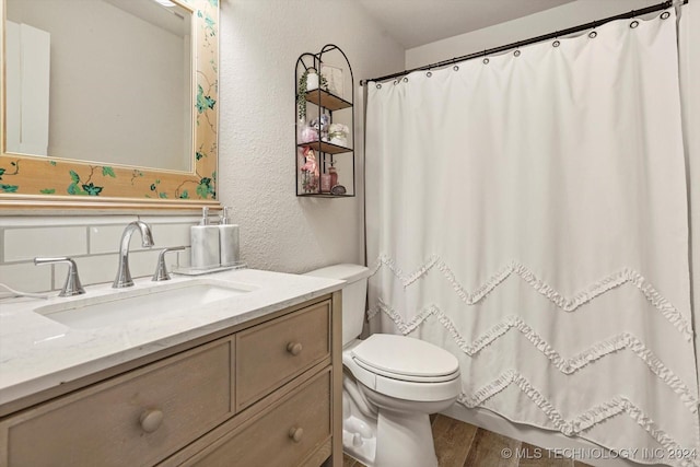 bathroom with vanity, hardwood / wood-style flooring, and toilet