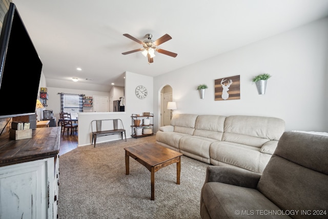 living room featuring ceiling fan and carpet flooring