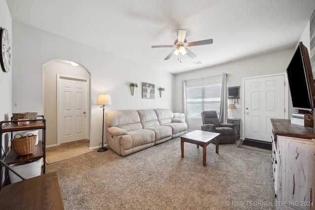 carpeted living room with ceiling fan