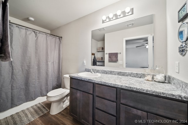 bathroom featuring toilet, ceiling fan, hardwood / wood-style floors, and vanity