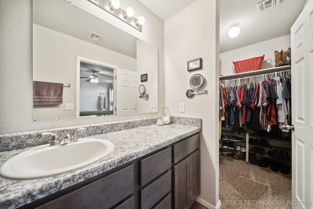 bathroom featuring ceiling fan and vanity