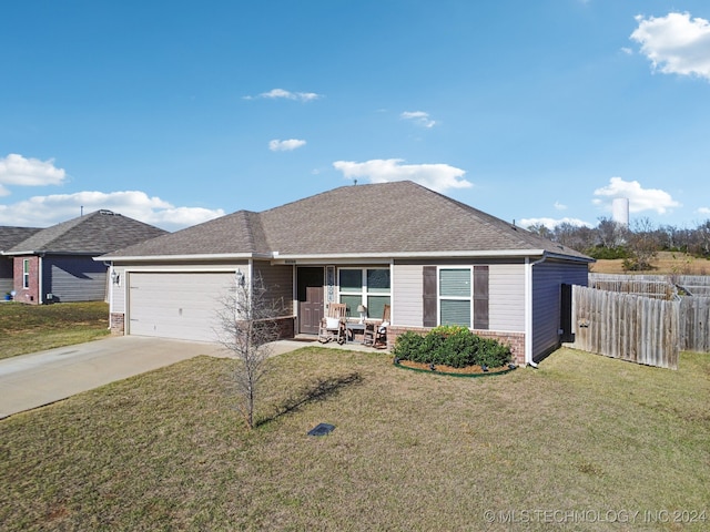 single story home featuring a garage and a front yard