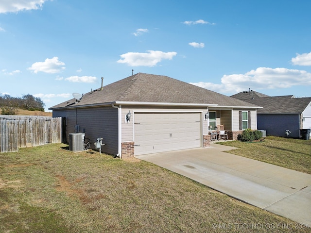 exterior space with a front yard, a garage, and cooling unit