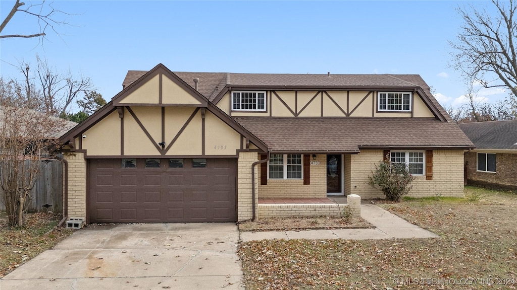 tudor home featuring a garage