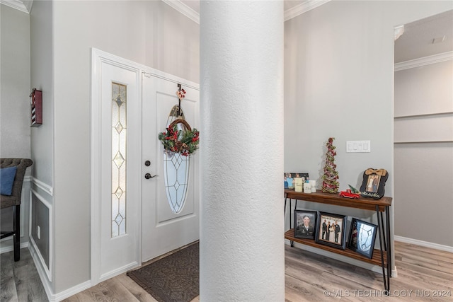 entryway with light hardwood / wood-style floors and ornamental molding