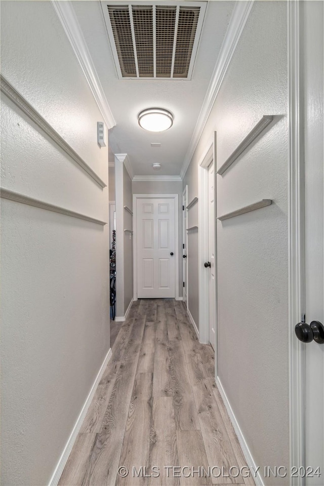 hallway featuring light hardwood / wood-style flooring and ornamental molding