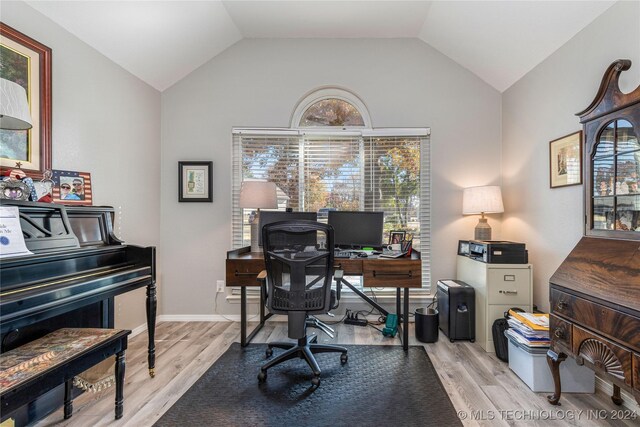 office featuring lofted ceiling and light wood-type flooring