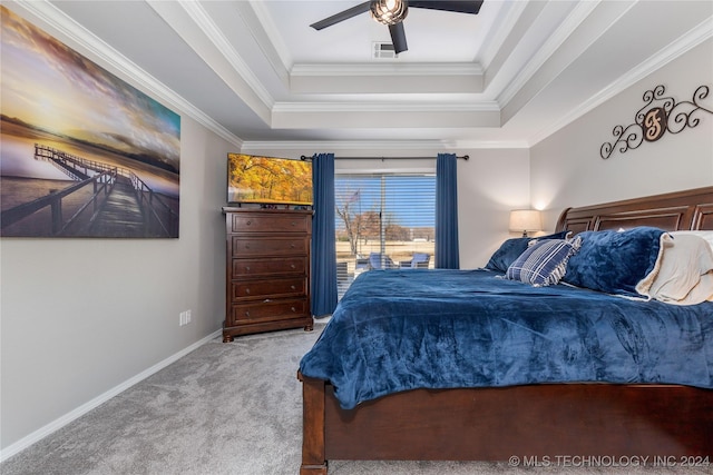 bedroom with carpet, a raised ceiling, ceiling fan, and ornamental molding