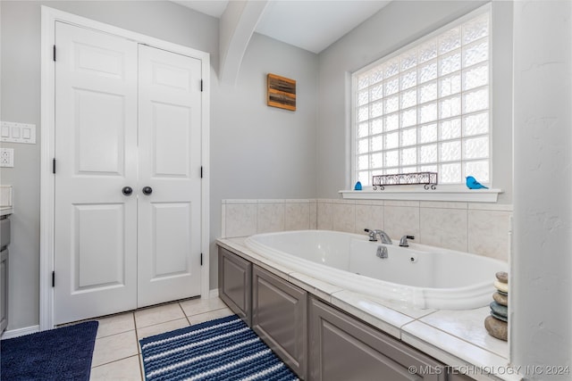 bathroom with tile patterned flooring and a bathing tub