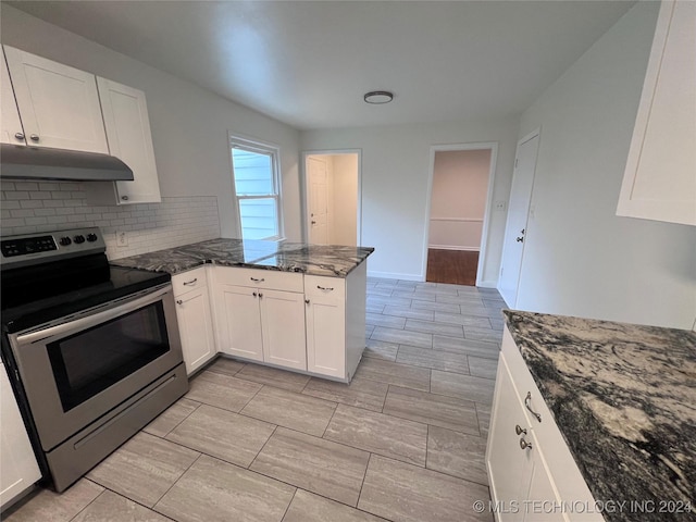 kitchen with backsplash, white cabinets, dark stone counters, and stainless steel electric range