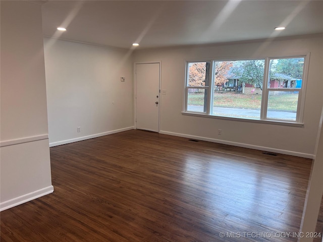 unfurnished room with dark hardwood / wood-style flooring, plenty of natural light, and ornamental molding