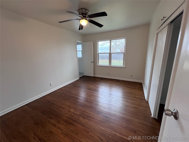 spare room with ceiling fan and dark hardwood / wood-style floors