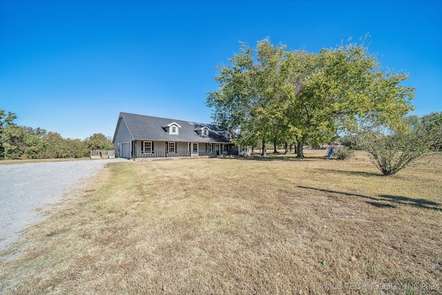 view of front of house with a front yard and a porch