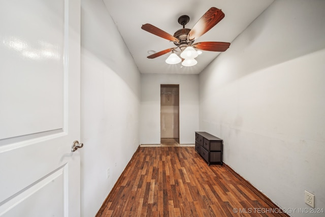 empty room with ceiling fan and dark wood-type flooring