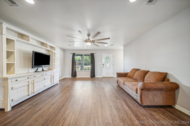 living room with dark hardwood / wood-style floors and ceiling fan