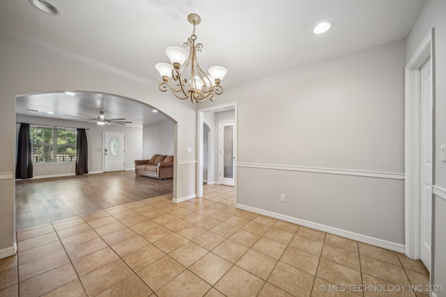 interior space featuring light hardwood / wood-style floors and ceiling fan with notable chandelier