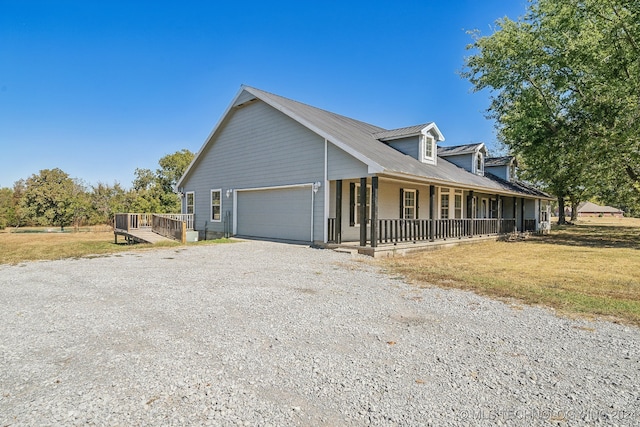 view of front of property featuring a porch and a garage