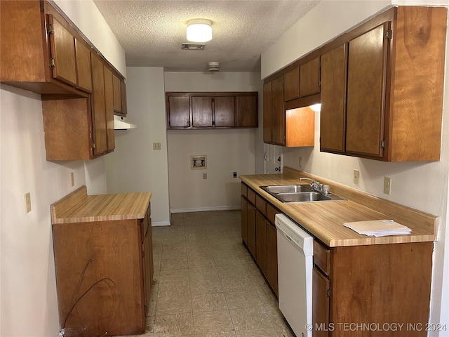 kitchen with dishwasher, a textured ceiling, and sink