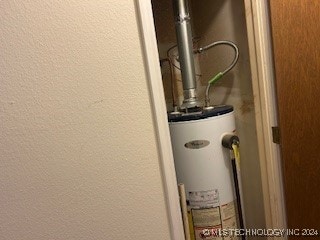 utility room featuring water heater