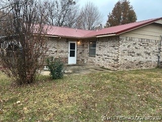 rear view of house with a yard