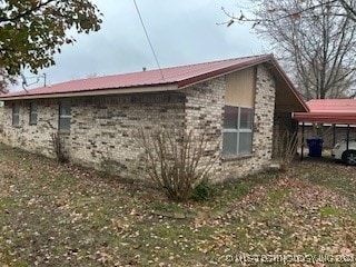 view of home's exterior featuring a carport