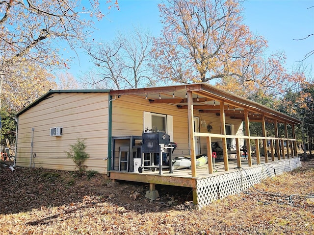 rear view of property with a wooden deck