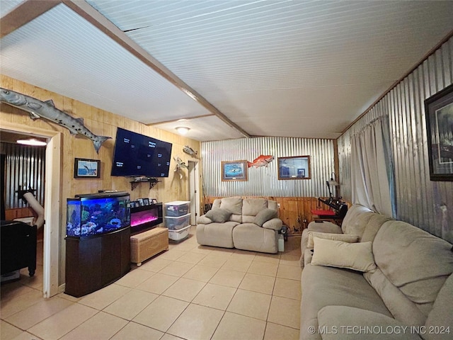 tiled living room with beamed ceiling and wood walls