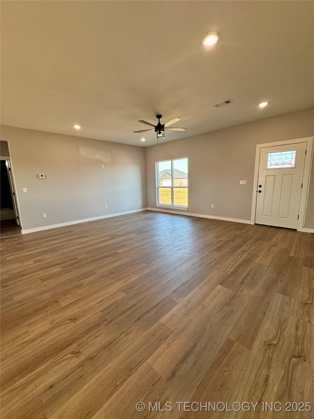 unfurnished living room with recessed lighting, baseboards, wood finished floors, and a ceiling fan