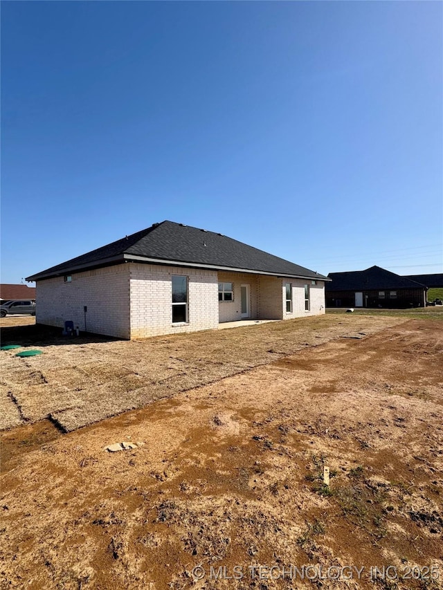 back of house with brick siding