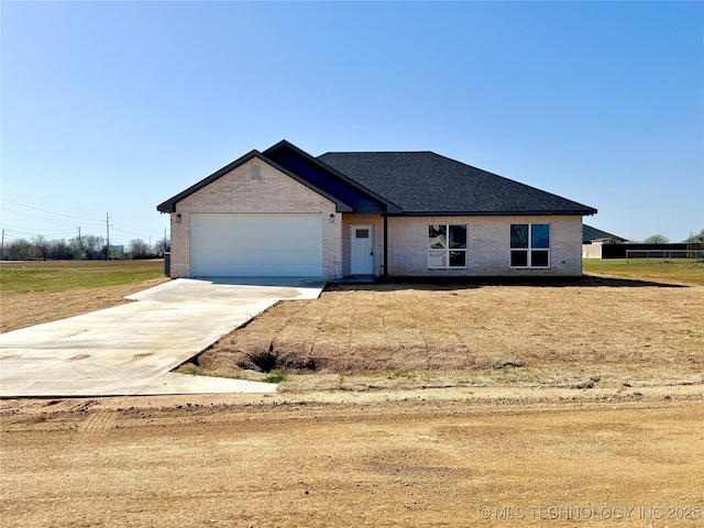 view of front facade featuring a garage, brick siding, and concrete driveway