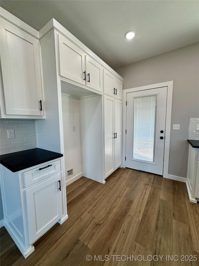 kitchen with visible vents, tasteful backsplash, dark countertops, and white cabinets