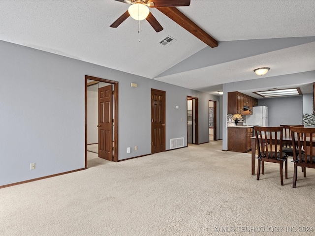 interior space with a textured ceiling, lofted ceiling with beams, ceiling fan, and light carpet