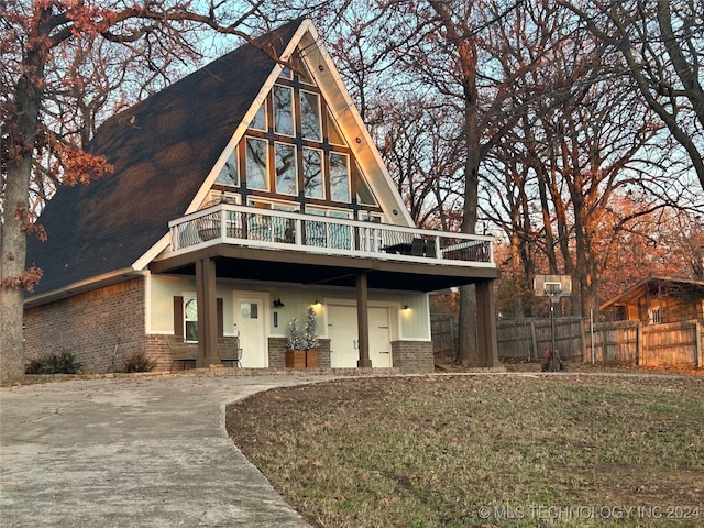 rear view of property featuring a lawn and a garage