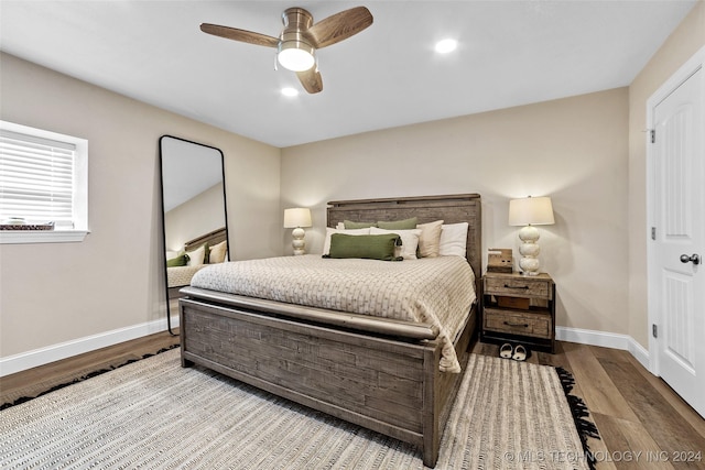 bedroom featuring hardwood / wood-style floors and ceiling fan