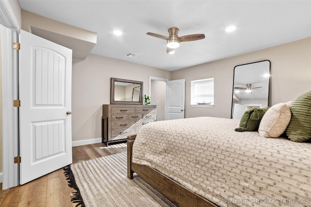 bedroom with light hardwood / wood-style flooring and ceiling fan