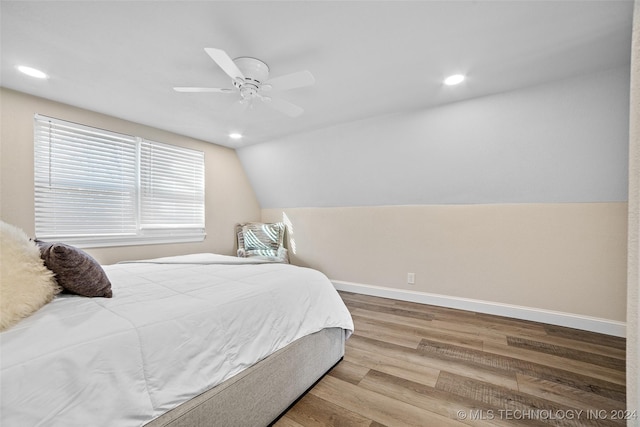 bedroom featuring ceiling fan, vaulted ceiling, and hardwood / wood-style flooring